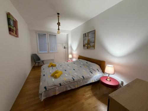a bedroom with a bed with a yellow stuffed animal on it at Ana VS Apartment in Ohrid