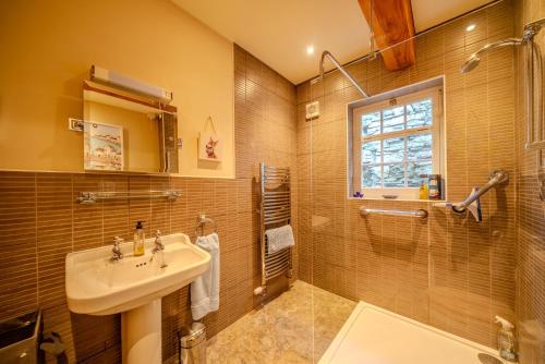 a bathroom with a sink and a shower at Cantre Selyf in Brecon