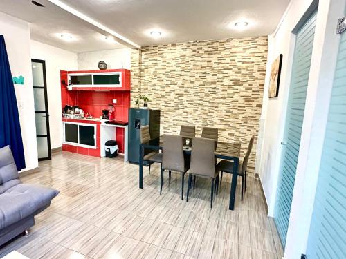 a kitchen and dining room with a table and chairs at Alojamientos Xolotl in La Concepción
