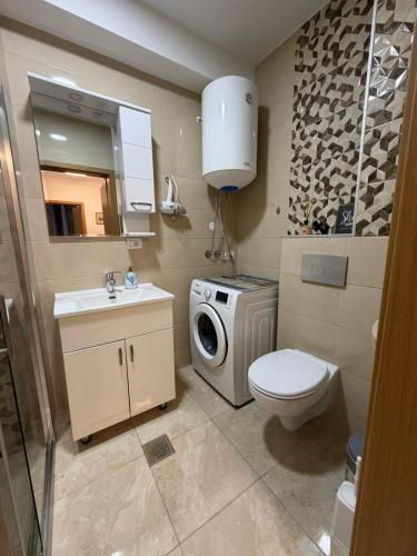 a bathroom with a washing machine and a washer at Ana VS Apartment in Ohrid