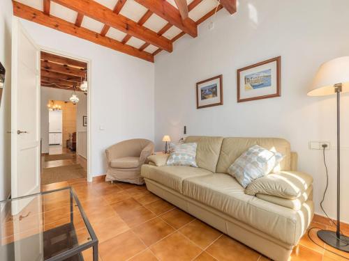 a living room with a couch and a glass table at Casa Major by 3VILLAS in Fornells