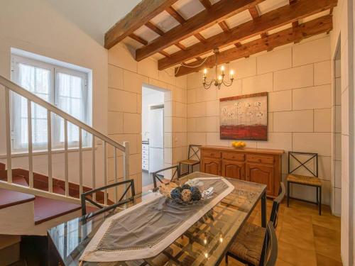 a dining room with a glass table and stairs at Casa Major by 3VILLAS in Fornells