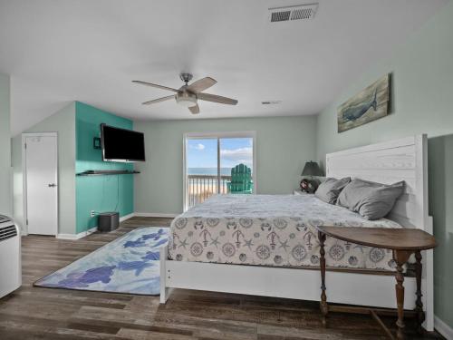 a bedroom with a bed and a ceiling fan at No Work Zone in North Topsail Beach
