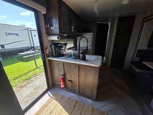 a kitchen in an rv with a sink and a window at Catchin Rays in North Topsail Beach