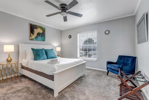 a bedroom with a bed and a blue chair at Denver Retreat in Arvada