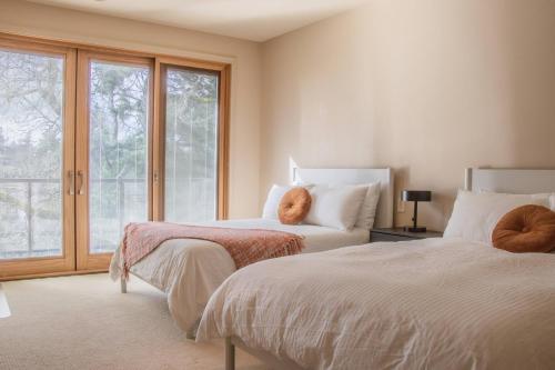 a bedroom with two beds and a window at Quiet Private Room with Ensuite Free Parking in Victoria