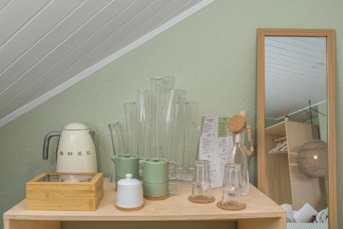 a shelf with a bunch of glass items on it at Achada do Teixeira Mountain Spot Lodge in Santana