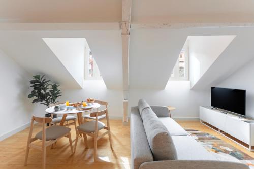 a living room with a couch and a table at Casa dos Aromas - Heritage & Comfort - ApartHotel in Coimbra