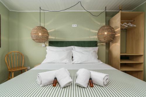 a bedroom with a bed with two towels on it at Achada do Teixeira Mountain Spot Lodge in Santana