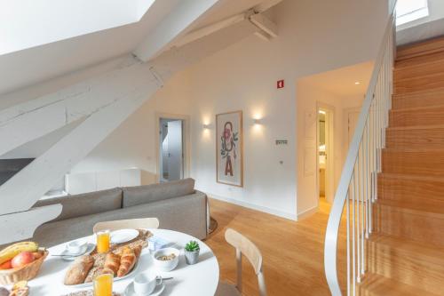a room with a table with food on it at Casa dos Aromas - Heritage & Comfort - ApartHotel in Coimbra