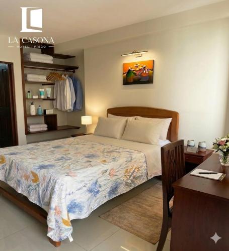 une chambre avec un grand lit et un bureau dans l'établissement Hotel La Casona, à Pisco