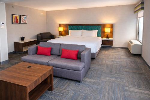 a hotel room with a bed and a couch at Best Western Cy-Fair in Houston