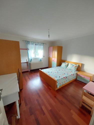 a large bedroom with a bed and a desk at Casa Flamingo in Viseu