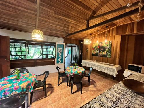 a living room with a table and chairs and a couch at Tekoah Pousada in Paranaguá