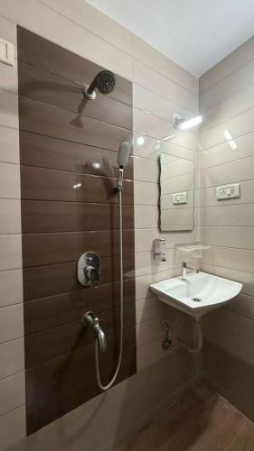 a bathroom with a shower and a sink at Spacious 2BHK flat in new panvel in Navi Mumbai