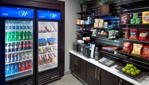 a grocery store aisle with a refrigerator and drinks at Waterfront Hotel Downtown Burlington in Burlington