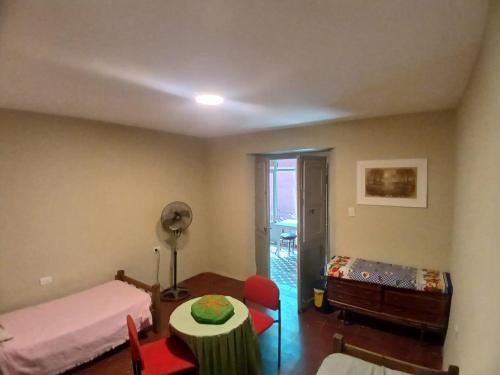 a room with two beds and a table in it at La Casona Hostel in Bermejo