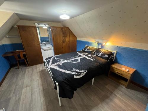 a bedroom with a large bed with a dragon blanket at Les Roitelets "MARINE" Appartement T4 Duplex 80m2 - Thème Marin - Entièrement NEUF - Classé 3 étoiles - Proche Centre-ville & Thermes - Tout Confort - Ménage et Linge de maison INCLUS in La Bourboule