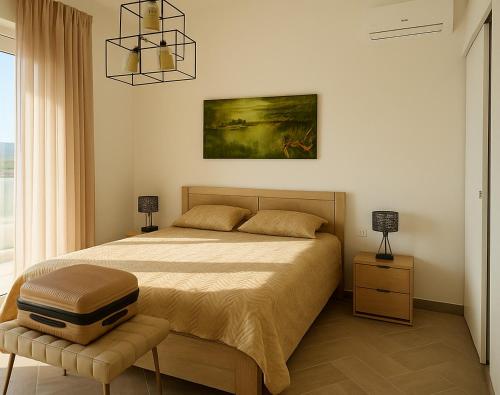 a bedroom with a large bed and a window at Theologos Residencies in Theologos