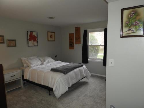 a bedroom with a bed and a window at CONDO 101c in Camp Hill