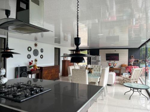 a kitchen with a stove and a dining room at Finca Bellavista in Villeta