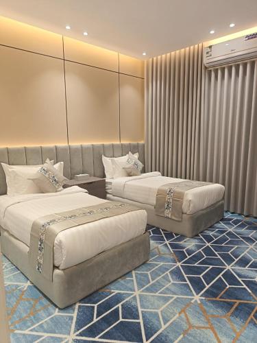 a hotel room with two beds in a room at لافيرا هاوس in Taif