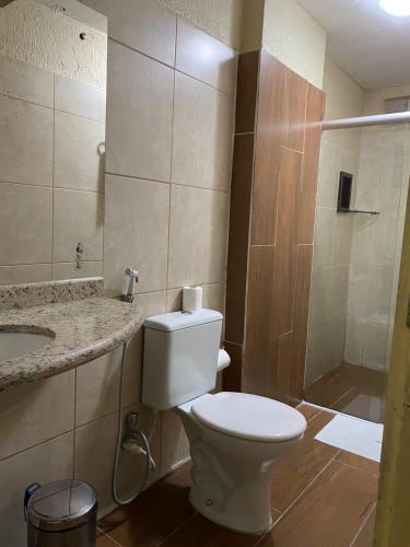 a bathroom with a toilet and a sink and a shower at Hotel orla House in Petrolina