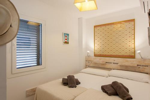a bedroom with two beds and a window at Lankarifa Apartment in Tarifa