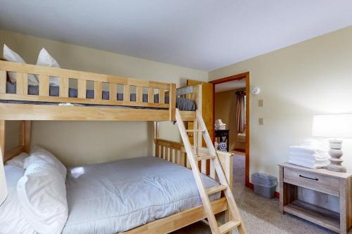 a bedroom with two bunk beds and a desk at Samoset Vacation in Gilford