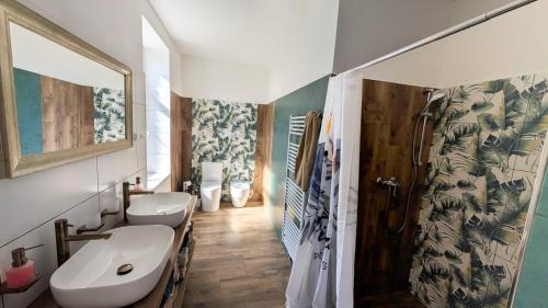 a bathroom with two toilets and a sink and a shower at Statek Osmička in Dolní Hořice