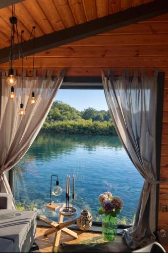 a view of a river from a room with a window at Paul Lake Escape Residence in Novosëlki