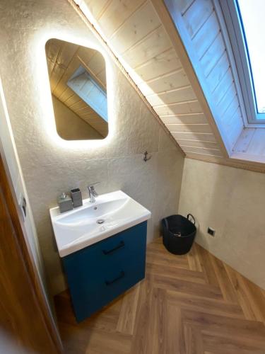 a bathroom with a sink and a skylight at Białe Żagle Mazury in Węgorzewo