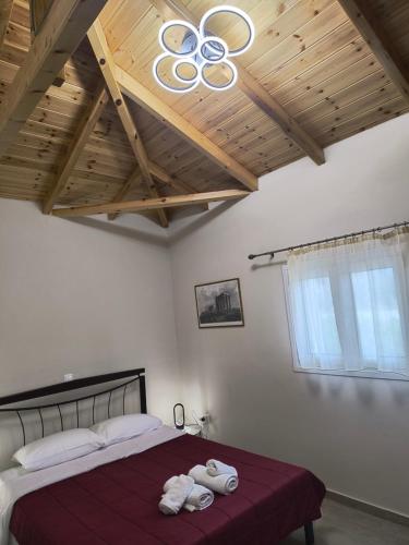 a bedroom with a large bed with towels on it at Avocado house in Finikounta