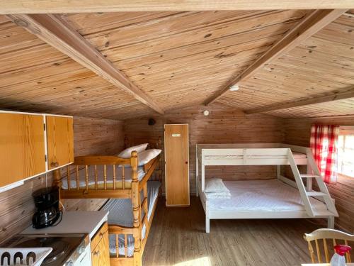 a room with two bunk beds in a cabin at Sikhall Camping & Restaurang in Sörbo
