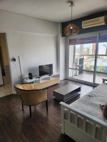 a bedroom with a bed and a tv and a couch at Apart Rucapel in General Roca