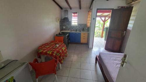 a small kitchen with a table and a stove at Bellevue Studios in Mare Gaillard