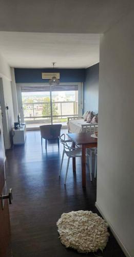 a living room with a table and a dining room at Apart Rucapel in General Roca