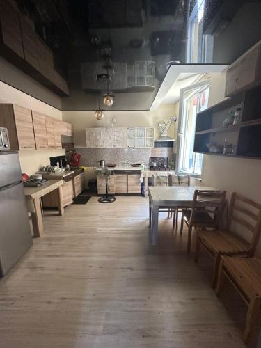 a kitchen with a table and chairs and a table and a kitchen at Barakat Hotel in Ureki