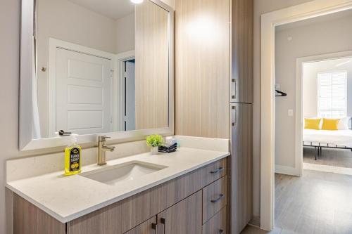 a bathroom with a sink and a mirror at 1200sf 2bed 2bath Apt near Medical City, Toyota Stadium and The Ford Center in Frisco