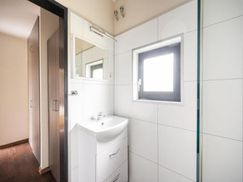 a bathroom with a sink and a mirror at Hambachtal nature hideaway boutique resort in Oberhambach