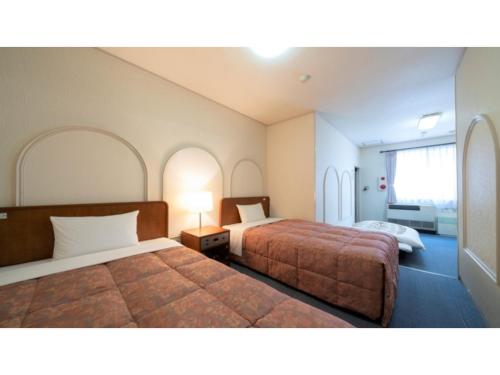 a hotel room with two beds and a window at Royal Hotel Uohachi - Vacation STAY 71042v in Toyota
