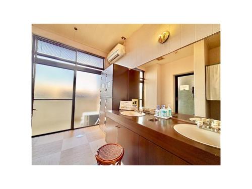 a bathroom with two sinks and a large mirror at Royal Hotel Uohachi - Vacation STAY 71048v in Toyota