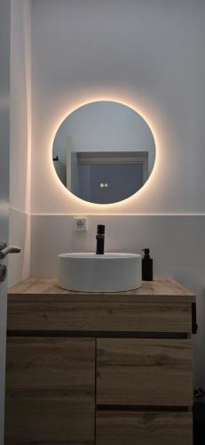 a bathroom with a white sink and a mirror at Casa da Picoteira - Pool - Pets - EV Charger in Proença-a-Nova