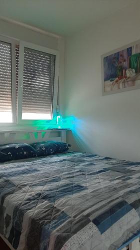 a bedroom with a bed with a blue light at Apartman Suva reka in Leskovac