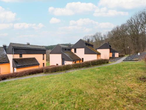 a row of houses on a grassy hill at Hambachtal forest hideaway boutique resort in Oberhambach