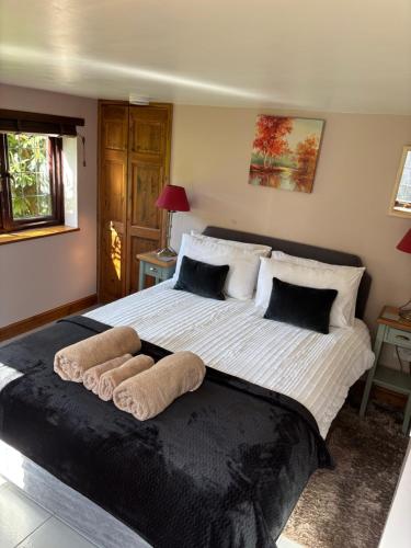 a bedroom with a large bed with towels on it at The Annexe at Gomo in East Winch