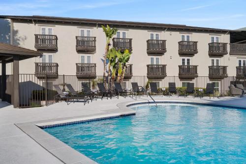 a hotel with a swimming pool in front of a building at Fairfield Inn & Suites San Diego Old Town in San Diego