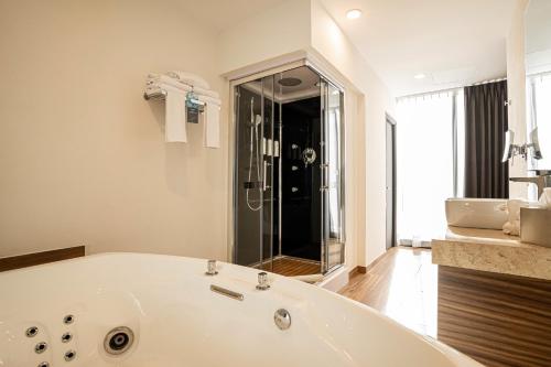 a large white bath tub in a bathroom at Radisson San Luis Potosi Aeropuerto in Santa Ana