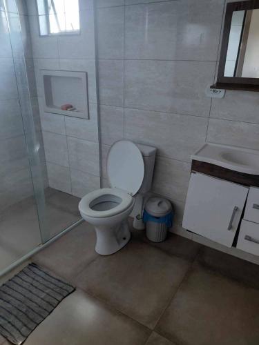 a bathroom with a toilet and a sink at Estância arco iris in Regente Feijó
