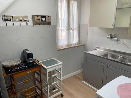 a small kitchen with a sink and a counter at Arkem's home in Norma